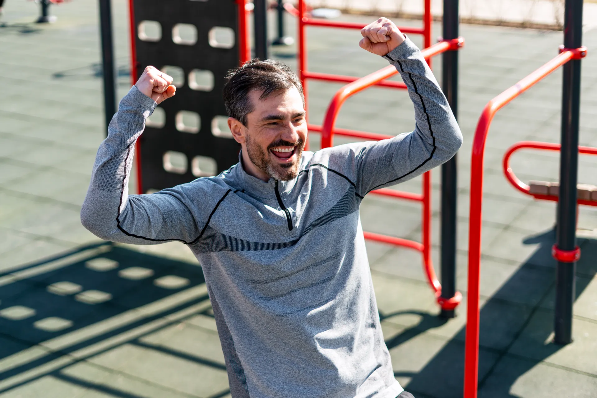 cheerful man celebrating achievement at an outdoor utc