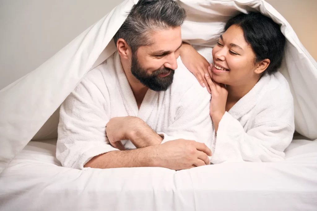 happy woman and man resting in hotel room utc