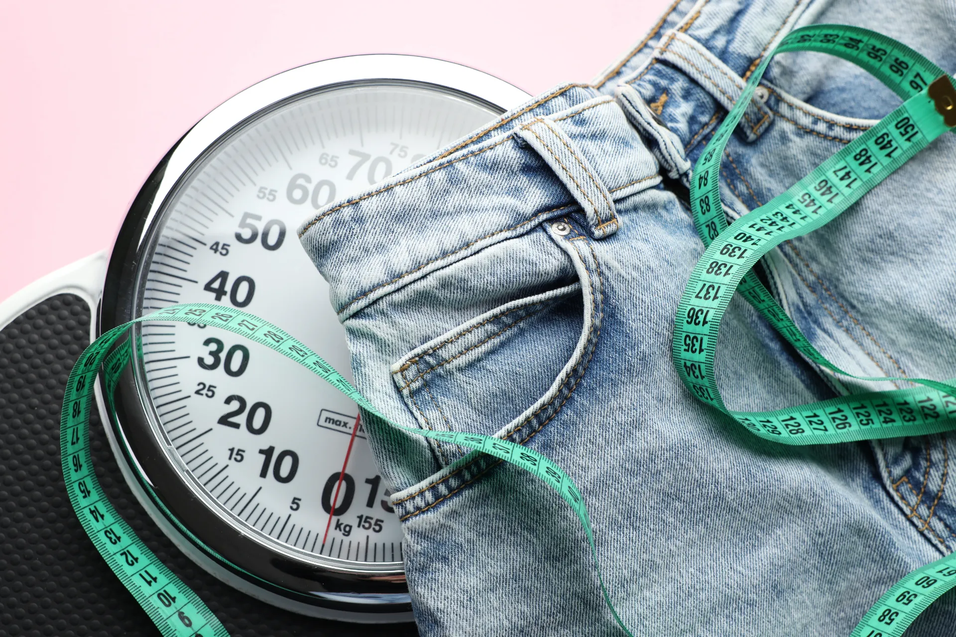 jeans with measuring tape and scales on pale pink utc