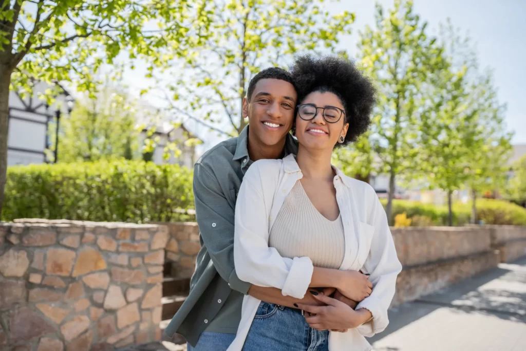 romantic young couple embracing in a green park utc