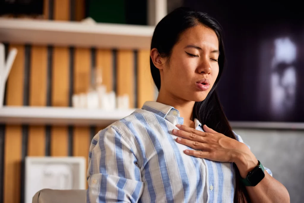 woman meditating indoors with eyes closed utc